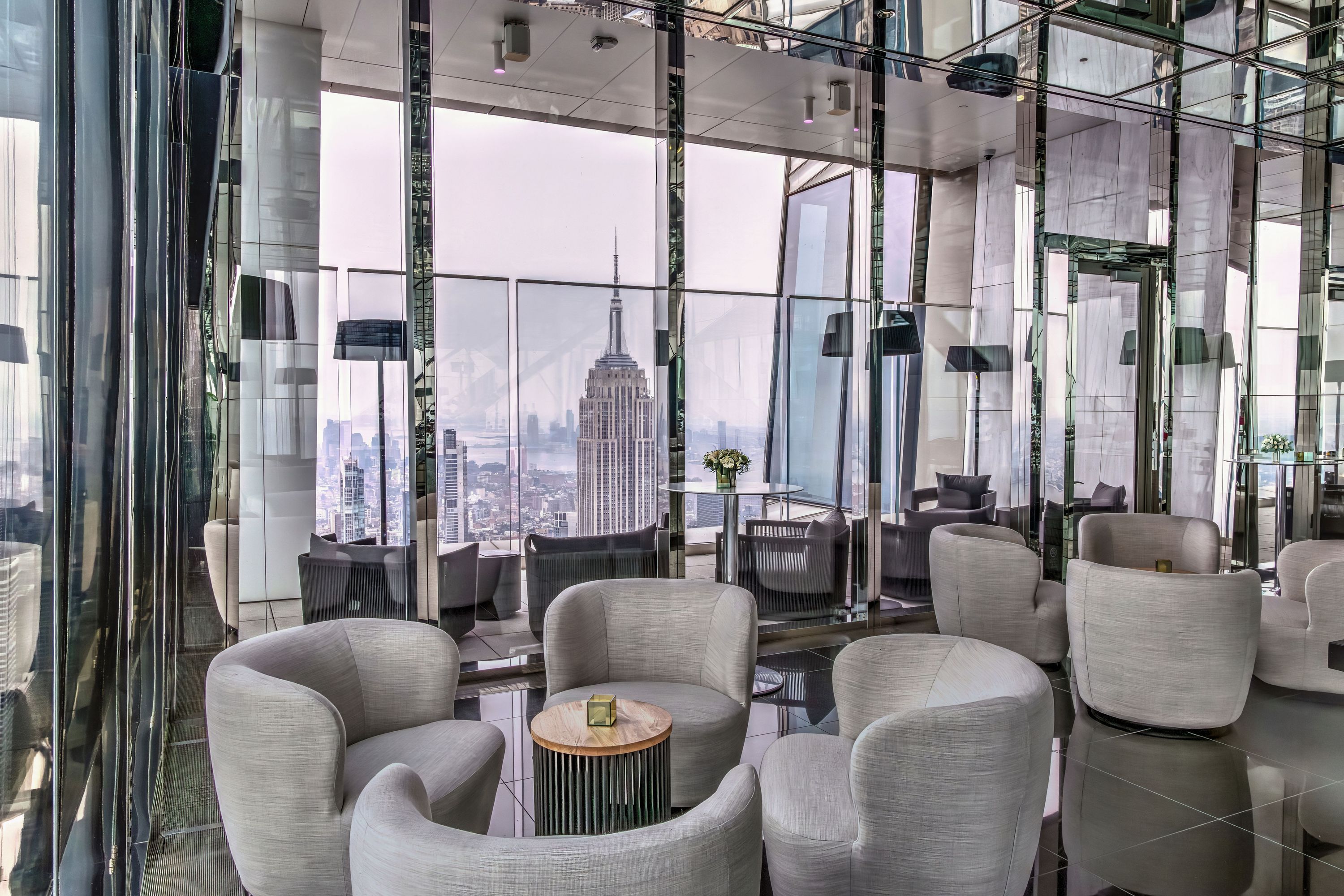 Spacious modern event space with seating arrangements and stunning views of the Empire State Building.